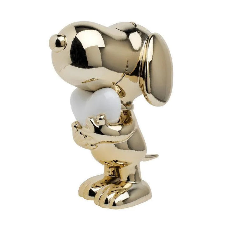 Gold metallic Snoopy sculpture holding a white heart, modern pop art collectible figure